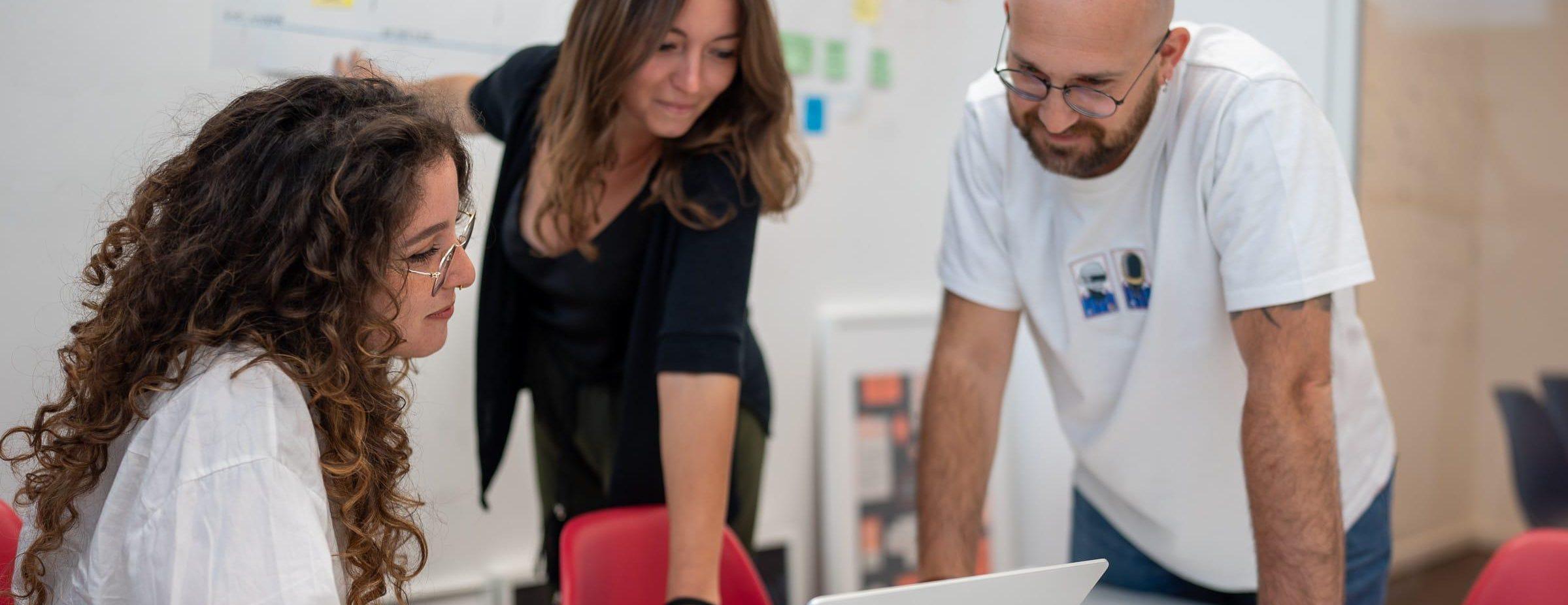 Giorgia, Giada, and Federico working during a co-design session.