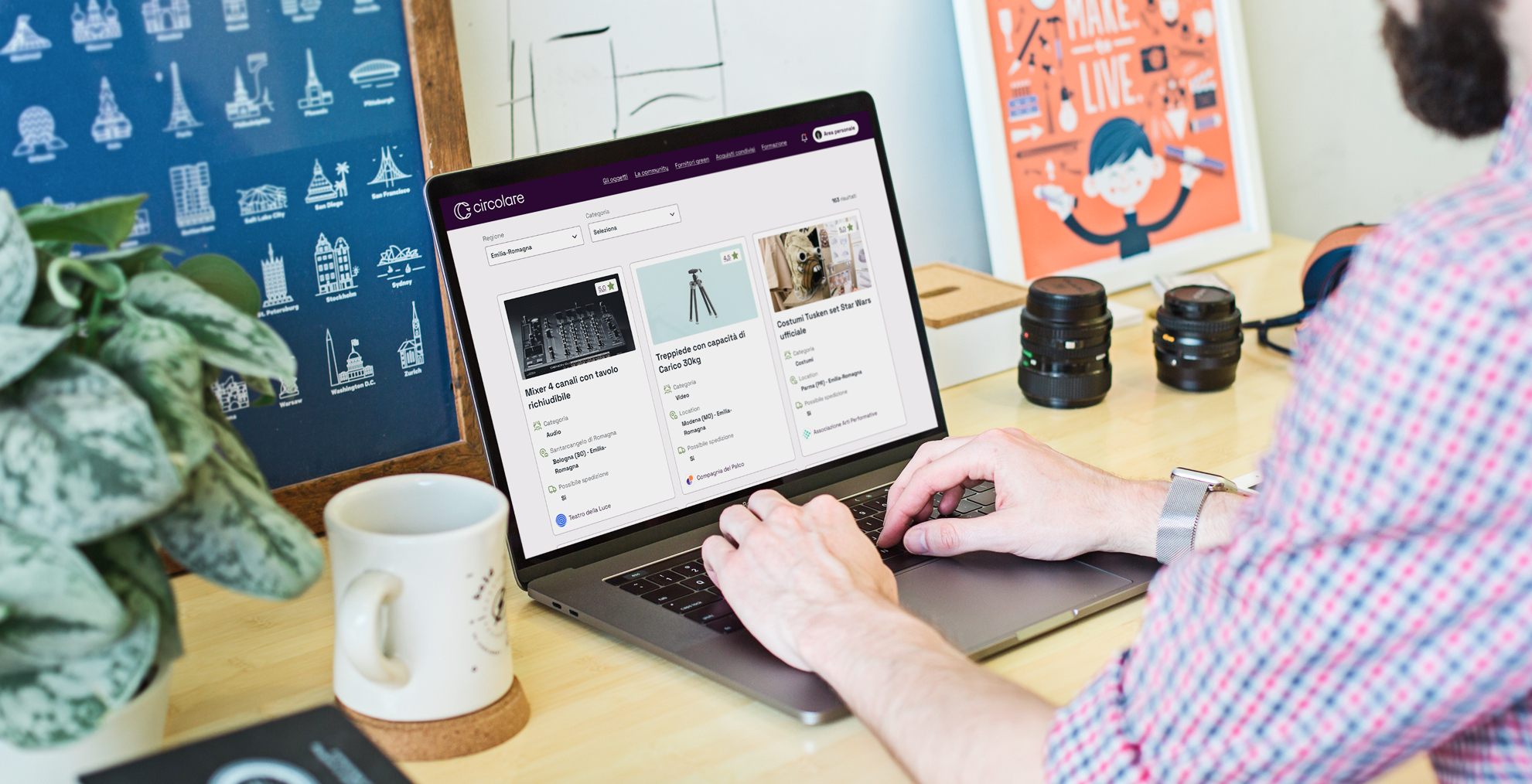 Person sitting at a desk uses the Circular platform on a laptop. The screen shows cards of objects available for loan between cultural institutions.