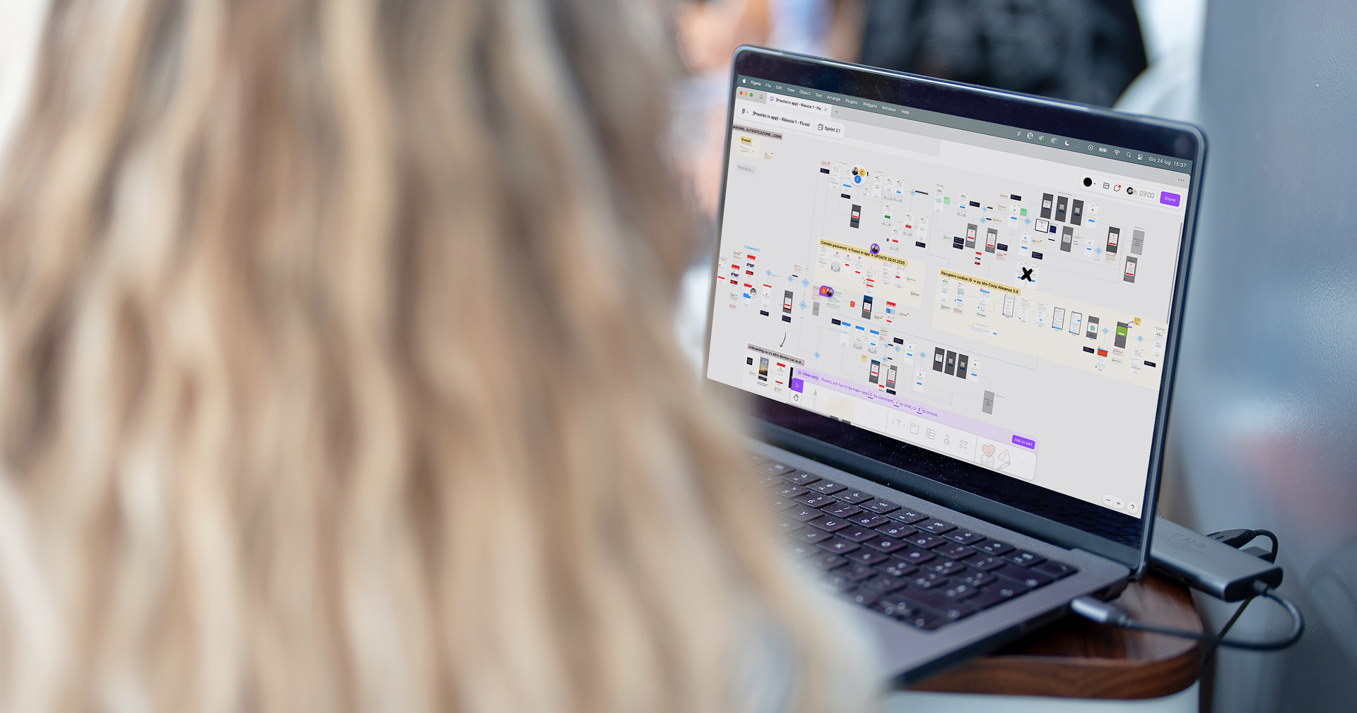 Person working on a digital board with the flows and screens of the Coop app.